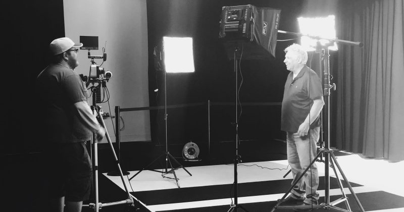 Image of 2 men in the Ignite Studio, surrounded by lights and cameras