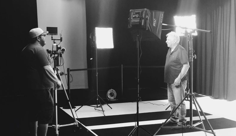 Image of 2 men in the Ignite Studio, surrounded by lights and cameras